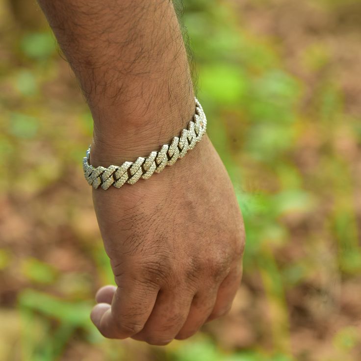 Introducing the Jewels Essence 8" Stainless Steel Cuban Link Chain Bracelet – a symbol of sophistication and enduring style. This masterpiece embodies the essence of modern elegance, seamlessly blending the iconic Cuban link design with the luster of stainless steel. Crafted for both men and women who appreciate the finer things in life, this bracelet is more than an accessory; it's a statement. Specifications: Length: 8 inches, providing a perfect fit for a variety of wrist sizes. Material: Premium-grade Stainless Steel, chosen for its durability and hypoallergenic properties. Gemstone: Adorned with Cubic Zirconia, offering the brilliance of diamonds without the extravagant cost. Closure: Secure Buckle, ensuring that the bracelet remains safely clasped. Chain Style: Curb (Cuban Link), is Luxury Silver Link Chain Bracelet, White Gold Cuban Link Bracelet With Solid Construction, Adjustable Silver Cuban Link Metal Bracelet, Luxury Silver Cuban Link Chain Bracelet, Luxury Silver Cuban Link Bracelet, Luxury Silver Metal Cuban Link Bracelet, Modern Bracelets With Box Chain And Cuban Link, Elegant Stainless Steel Cuban Link Bracelet With Box Chain, Modern Cuban Link Chain Bracelet With Solid Construction