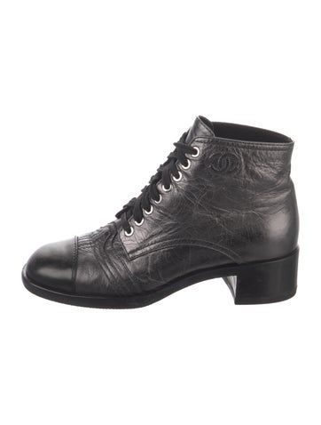 Chanel Lambskin Ankle Combat BootsFrom the 2018 Collection by Karl LagerfeldMetallic & SilverInterlocking CC LogoRound-ToesLace-Up Closure at UppersIncludes BoxFit: This style typically runs a full size small. Chanel Combat Boots 2022, Chanel Boots Farfetch, Chanel Black Ankle Boots, Cc Logo, Boot Shoes Women, Combat Boots, Shoe Boots, Chanel, Women Shoes