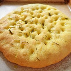 a close up of a bread with herbs on it