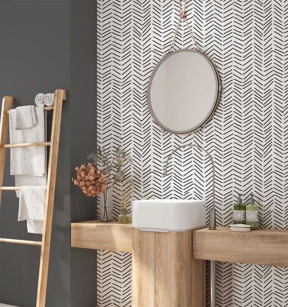 a bathroom with a ladder next to it and a mirror on the wall above the sink