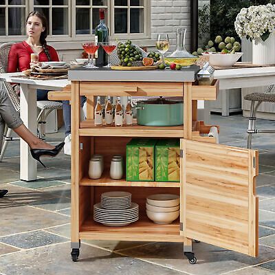 a woman sitting at a kitchen island with plates and glasses on it, in front of an outdoor dining table