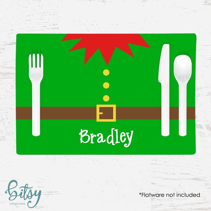 a green place mat with a santa hat on it and spoons, fork and knife