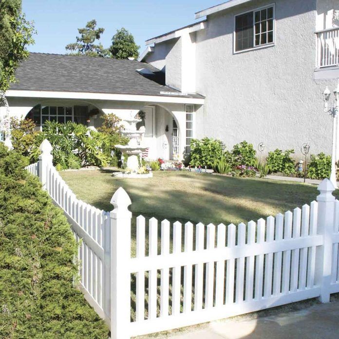 a white picket fence in front of a house