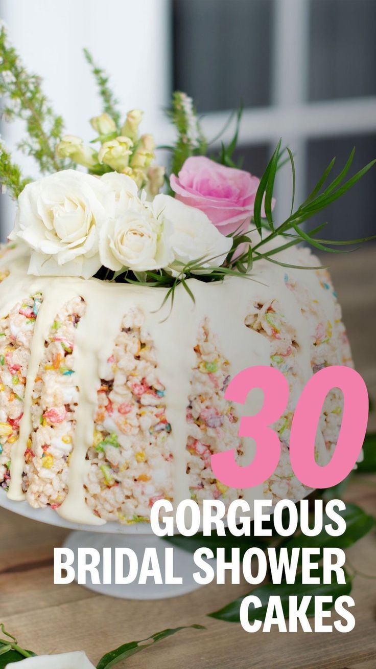 a cake with white frosting and flowers on top