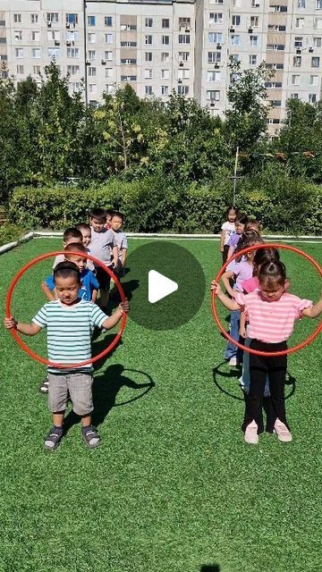 children are playing with hoop rings in the grass