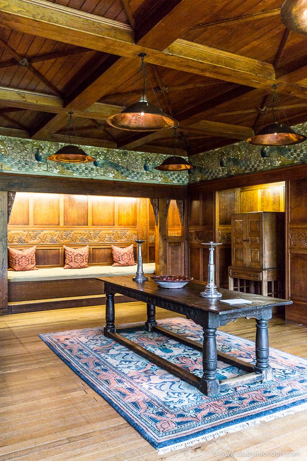 a room with wood paneling and wooden furniture on the floor, along with a large rug