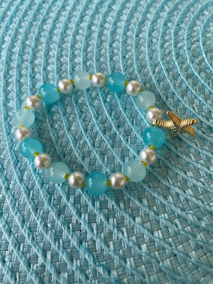 A cute beach/summer themed bracelet that's handmade. It comes in many different sizes. A perfect bracelet to wear during summertime! Turquoise Ocean-inspired Bracelet With Starfish Charm, Ocean-inspired Turquoise Bracelet With Starfish Charm, Handmade Turquoise Starfish Bracelets, Summer Themed Bracelets, Beach Theme Bracelets, Starfish-shaped Beaded Vacation Bracelets, Ocean-inspired Beaded Bracelet For Beach Season, Summer Strand Beaded Bracelets With Starfish Charm, Summer Beaded Bracelet With Starfish Charm