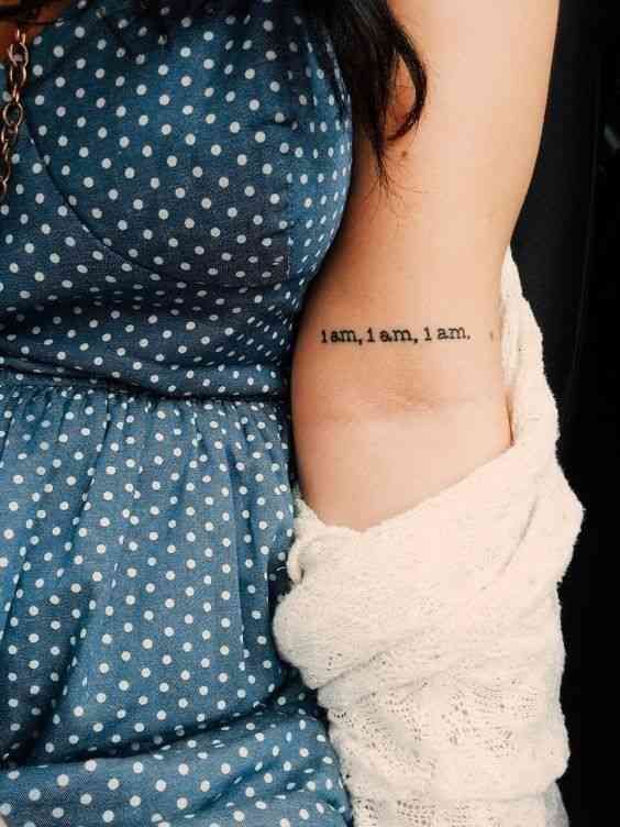 a woman with a tattoo on her arm that says i am not afraid to learn