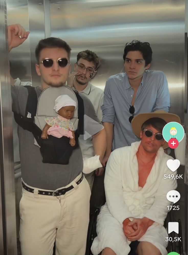 a group of young men standing next to each other in front of an elevator door