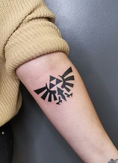 a woman's arm with a tattoo on it that has an image of the legend of zelda