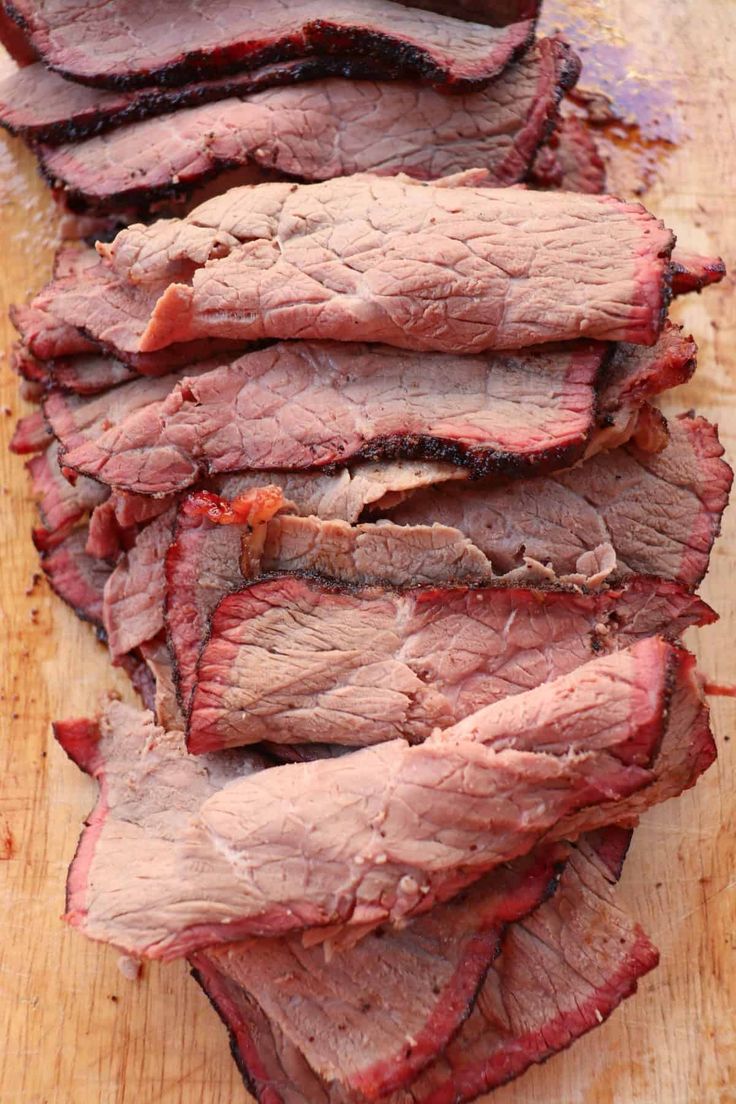 sliced beef on a cutting board ready to be cooked