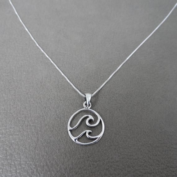 A delicate Wave/Ocean sterling silver necklace.This necklace is made of Sterling Silver with a 18" box chain.The pendant on the necklace is a double wave and measures 14mm.Your necklace will be shipped in a gift box. Silver Wavy Necklace For Gift, Sterling Silver Wavy Necklace For Gifts, Surf Necklace, Surfer Jewelry, Wave Pendant, Wave Jewelry, Beach Necklace, Wave Necklace, Surfer Necklace