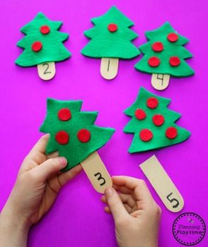 someone is making christmas trees out of construction paper and glue with the numbers on them