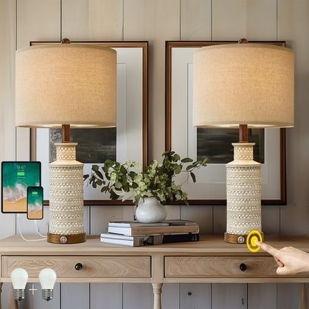 two lamps sitting on top of a wooden table