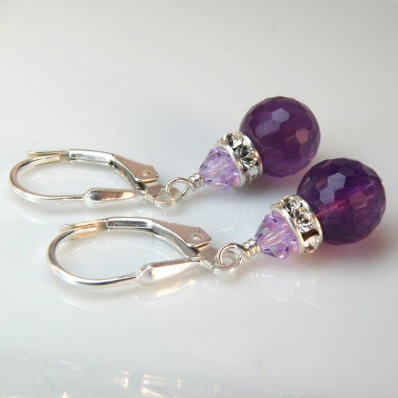 Gorgeous purple amethyst gemstones make for a beautiful pair of earrings. These finely faceted amethysts refract more light and have more added sparkle. Gorgeous AAA quality gemstones are accented with Swarovski crystal rhinestone crowns for more dazzle.This earring length is perfect to be worn everyday from the office cube to afterwards at happy hour. A fabulous genuine stone pair of earrings to gift for your bridesmaids on your wedding day.Earring Details:- Amethyst gemstone is 8 mm round and Elegant Purple Teardrop Gemstone, Amethyst Gemstone Earrings For Party, Purple Amethyst Earrings For Wedding, Amethyst Purple Earrings For Wedding, Amethyst Earrings With Gemstone Accents For Wedding, Purple Gemstone Accented Round Earrings, Handmade Amethyst Earrings For Wedding, Round Purple Earrings With Gemstone Accents, Amethyst Gemstone Earrings For Wedding