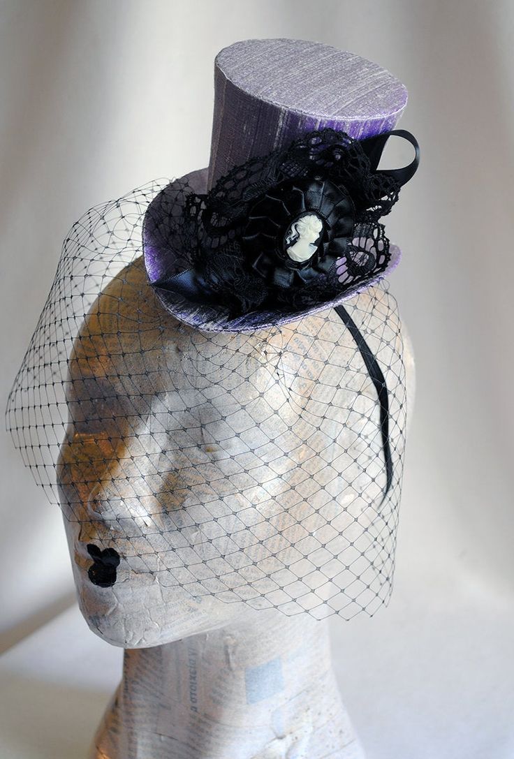 This victorian goth mini top hat is a simple yet elegant piece.It is covered with black silk shantung and adorned with black satin ribbon in a vertical half bow, vintage black cotton lace in a rosette, pleated satin ribbon, which forms an oval frame for a beautiful black and white victorian profile cameo. Choose between with or without black veil. Also available in a white and black combination: https://www.etsy.com/bizarrenoir/listing/166826619/gothic-mini-top-hat-in-purple-velvet?ref=shop_home Witchy Brimmed Costume Hats For Parties, Handmade Fitted High Crown Mini Hats, Gothic High Crown Costume Hat, Handmade Fitted Mini Hat With High Crown, Gothic Top Hat With Short Brim For Halloween, Gothic Fitted High Crown Costume Accessories, High Crown Top Hat For Halloween, Fitted Witchy Party Hat, Witchy Fitted Party Hat