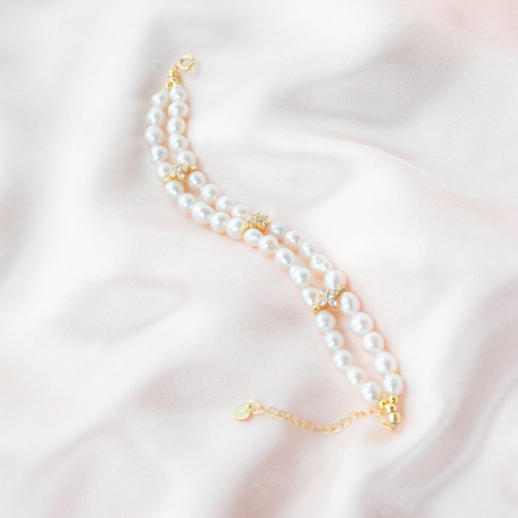 This Baroque bracelet features two layers of delicate chain adorned with sparkling four-leaf clover zircon pieces. The unique Baroque design adds a touch of vintage elegance, while the zircon accents add a touch of sparkle. Perfect for dressing up any outfit like wedding dresses or adding a touch of elegance to your everyday look. This bracelet is a must-have for any pearl jewelry lover. Pearl Type: Freshwater Baroque Pearls Pearl Quality: [Shape]: Baroque Irregular Shape [Pearl Size]: 6-7mm [Bl Fine Jewelry Pearl Bracelets For Wedding, Elegant Gold Plated Chain Bracelet With Diamond Accents, Fine Pearl Bracelets For Wedding, Gold Plated Elegant Jubilee Crystal Bracelet, Elegant Gold Plated Jubilee Crystal Bracelet, Elegant Wedding Chain Bracelet, Elegant Gold Chain Bracelet With Sparkling Stones, Elegant Gold Crystal Bracelet, Elegant Adjustable Pearl Chain Bracelet