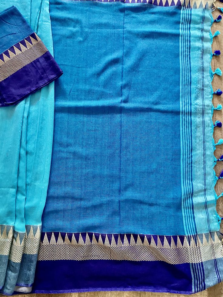 Beautiful Handloom Saree different shades of Ocean Colors (Blue) with Temple Borders Saree in Pure Khaadi. Item : Saree Color : Blue Base Fabric : Pure Khaadi Handloom Blouse piece : Comes with un-stitched Blouse piece. Blouse material : Pure Khaadi Handloom Work : Handloom Saree Fall & Edging : Comes with Fall and edging (Pico) done and Tassels attached Kindly note : Since this Saree is handmade hence little inconsistencies may be there however it is not considered as a defect. Every Saree Blue Pre-draped Saree With Zari Weaving For Navratri, Traditional Blue Pre-draped Saree With Dupatta, Traditional Blue Pre-draped Saree With Self Design, Festive Blue Handloom Pre-draped Saree, Blue Pre-draped Saree With Zari Weaving, Blue Cotton Silk Pre-draped Saree With Zari Weaving, Semi-stitched Blue Saree With Dupatta, Traditional Blue Pre-draped Saree For Navratri, Unstitched Blue Saree