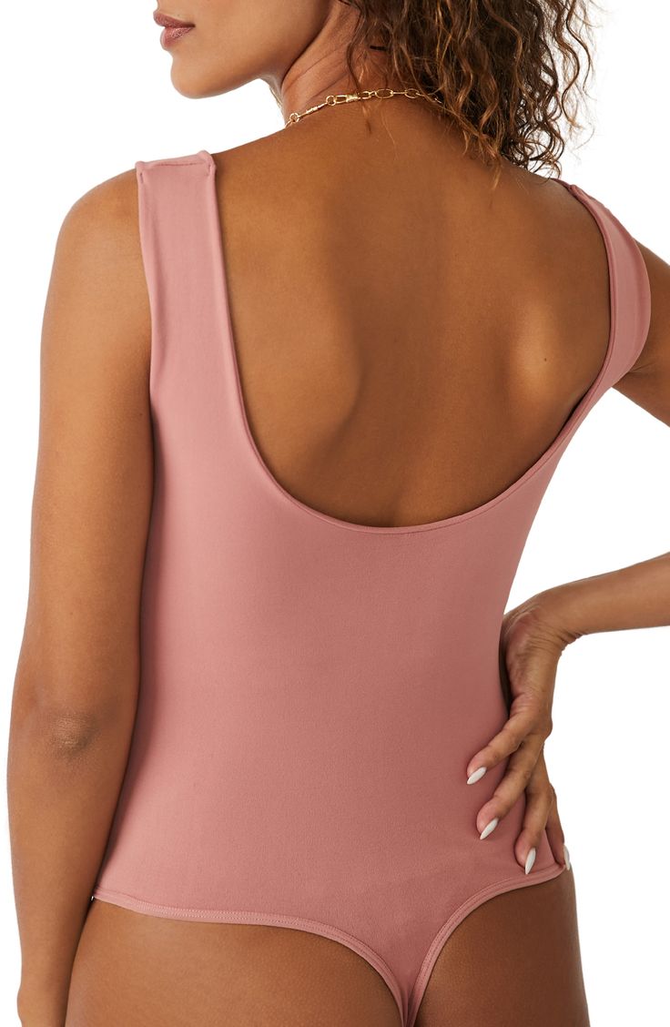 A sleek curve-hugging bodysuit featuring a dipped neckline and low U-back. Stretch fit Built-in shelf bra Snap gusset closure Thong cut 92% nylon, 8% elastane Machine wash, dry flat Imported Stretch Leotard With Built-in Bra And Scoop Neck, Pink Stretch Backless Bodysuit, Backless Stretch Pink Bodysuit, One-piece Second-skin Leotard With Built-in Bra, High Stretch Backless Bodysuit With Moderate Back Coverage, High Stretch Bodysuit With Moderate Back Coverage, Pink Second-skin Swimwear With Lined Body, Pink Backless Bodysuit With Lined Body, Fitted Scoop Neck Bodysuit Bra Friendly