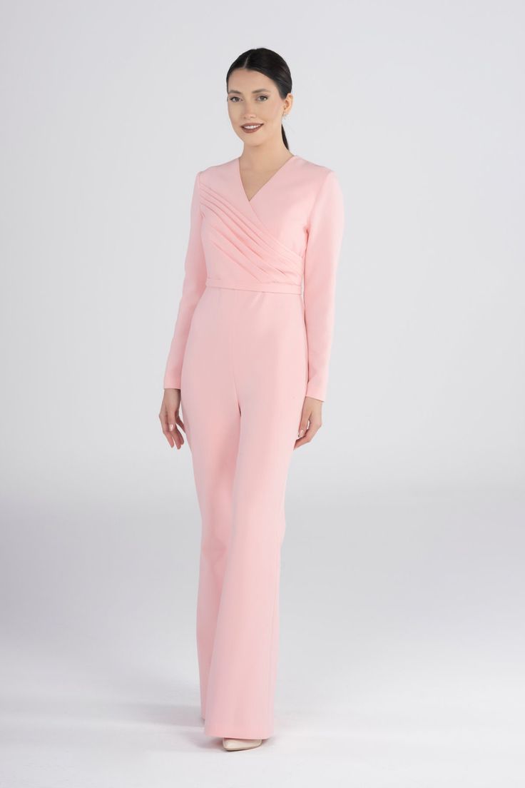 Elevate your style with our Elegant Pink Flare Pants Jumpsuit. This chic and trendy one-piece, designed for a stylish statement, brings together elegance and comfort. Whether it's a special occasion or a night out, this jumpsuit offers a unique blend of fashion-forward design and sophistication. Key Features: Elegant pink color and flare pants design Perfect for special occasions and stylish gatherings Comfortable and trendy women's fashion Unique statement piece for a fashionable look Make a lasting impression with this chic jumpsuit. Order now to add a touch of elegance and style to your wardrobe. Chic V-neck Suits For Spring, Elegant V-neck Cocktail Jumpsuits And Rompers, Elegant Fitted Jumpsuits And Rompers For Party, Elegant Fitted V-neck Jumpsuits And Rompers, Chic Fitted V-neck Pantsuit, Feminine V-neck Jumpsuits And Rompers For Night Out, Formal Full-length Jumpsuits And Rompers For Spring, Full Length Formal Jumpsuits And Rompers For Spring, Elegant Fitted Jumpsuit For Wedding Guest