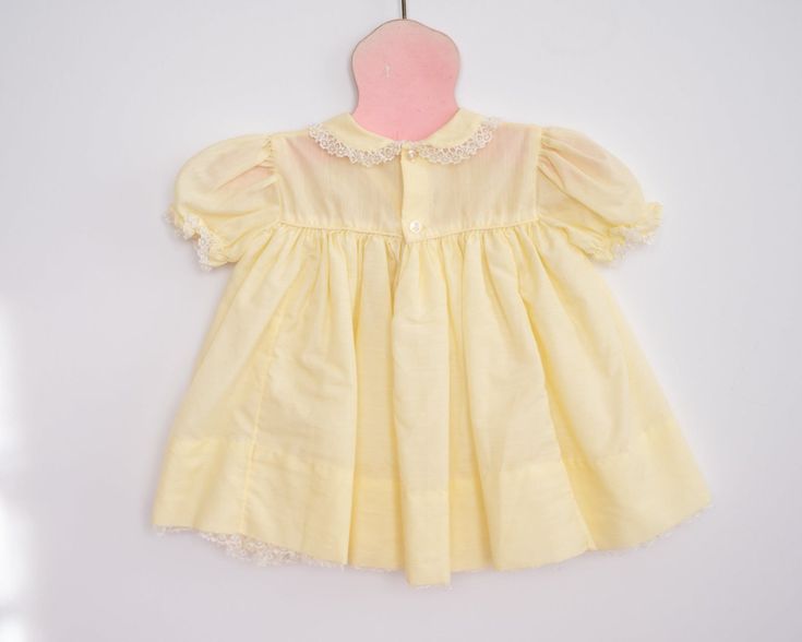 A sweet frock for a sweet little girl. This bright and cheery yellow dress has a crinolen layer sewn into the skirt. It features a sweet floral embroidery on the top and lace details. Approximately size 6-12 months, please see measurements below for best fit. Vintage Yellow dress Approximately 6-12 months Measurements: Shoulder to shoulder: 8 inches, chest 9.5 inches Has some brown lines/spots, pictured As with all vintage, we inspect each piece to determine any issues but we can not guarantee w Vintage Yellow Dress, Yellow Vintage Dress, Girls Yellow Dress, Vintage Baby Girl, Brown Line, Sweet Floral, 1950s Dress