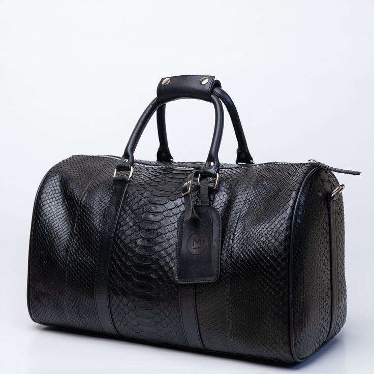 Mulat MULAT Black Python Duffel Bag Black Leather Trim Duffle Bag For On-the-go, Classic Black Textured Leather Travel Bag, Black Duffle Bag With Leather Trim Satchel, Black Leather Trim Travel Bag For Business, Black Duffle Bag With Leather Trim For On-the-go, Black Leather-lined Satchel Weekender Bag, Designer Black Satchel Duffle Bag, Black Textured Leather Luxury Duffle Bag, Classic Black Textured Leather Duffle Bag