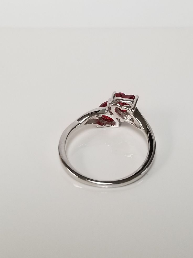 "Thanks for shopping our vintage estate store. We tend to sell well below wholesale and truly hope you enjoy all of our items. Many of the items are one of a kind, so please enjoy scrolling through the pictures and hopefully something will catch your eye. Black spots are from camera. Nice estate sterling silver 925 .50ct garnet heart with cz diamonds ring. This is a custom made ring from our shop, meaning we set the gems into the setting. Ring Size: please select a size Setting: 3/8\" 10mm Weigh Formal Rings With Prong Setting For Valentine's Day, Classic Bypass Ring With Prong Setting As Gift, Classic Silver Ruby Ring For Valentine's Day, Silver Heart-shaped Ruby Ring For Anniversary, Classic Round Ruby Ring For Valentine's Day, Classic Heart-shaped Ruby Ring, Classic Heart-shaped Ruby Ring For Formal Occasions, Silver Marquise Cut Ruby Promise Ring, Hallmarked Heart Ring For Valentine's Day Formal