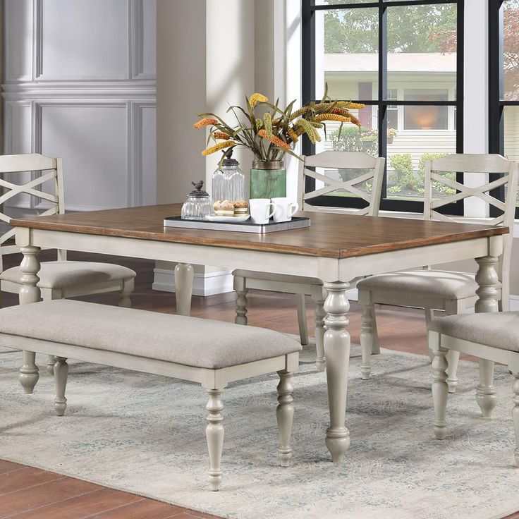 a dining room table with chairs and a bench