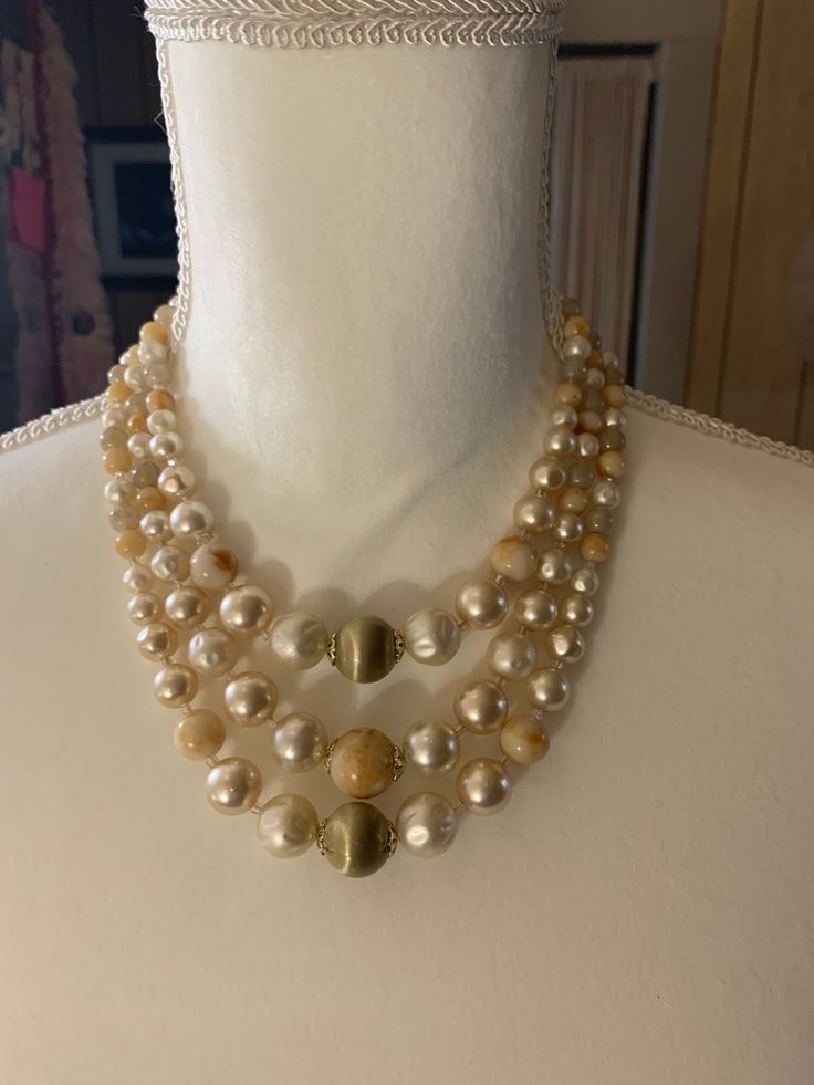 This Triple strand graduated faux pearl and glass bead necklace is beautiful! It is marked Japan, from the 50's or 60's . The marbled peach/orange beads are glass, the satin beads in the center are especially pretty. Check out all my items at VintageBlueBaboon. Vintage Beige Beaded Necklace, Vintage Beaded Beige Necklace, Vintage Pearl White Round Beads Necklace, Vintage Pearl White Round Bead Necklaces, Vintage Pearl White Necklaces With Round Beads, Vintage Pearl White Necklace With Round Beads, Vintage Pearl White Pearl Necklace With Round Beads, Vintage Pearl Necklace With Round Beads, Vintage Adjustable Beaded Pearl Necklace