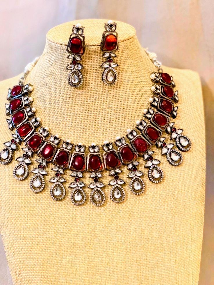 Red Polki Victorian Silver Necklace. Comes with matching earrings Elegant Red Jewelry Sets For Festive Occasions, Elegant Red Festive Jewelry, Festive Red Necklace With Matching Earrings, Festive Red Necklaces With Matching Earrings, Red Metal Necklaces For Party, Red Costume Jewelry Necklaces For Party, Festive Red Ruby Jewelry Set, Red Party Jewelry With Jewels, Red Ruby Jewelry Sets With Matching Earrings