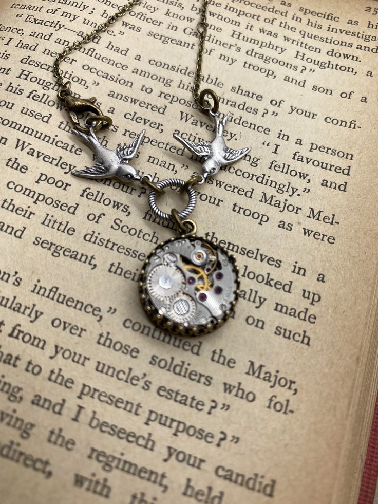 Swooping Sparrow Steampunk Necklace #VictorianNecklace #VictorianMagpie #MovementNecklace #SteamPunkSwallow #NewvictorianBirds #BirdNecklace #TimePieceNecklace #AntiqueBirdJewelry #VictorianJewelry #SwallowSteampunk Steampunk Brass Locket Jewelry, Steampunk Metal Pocket Watch With Locket, Steampunk Round Locket Jewelry, Steampunk Style Chain Jewelry As Gift, Adjustable Victorian Metal Necklace, Vintage Stainless Steel Chain Necklace, Steampunk Metal Locket Necklace, Steampunk Silver Pocket Watch With Locket, Silver Steampunk Pocket Watch With Locket