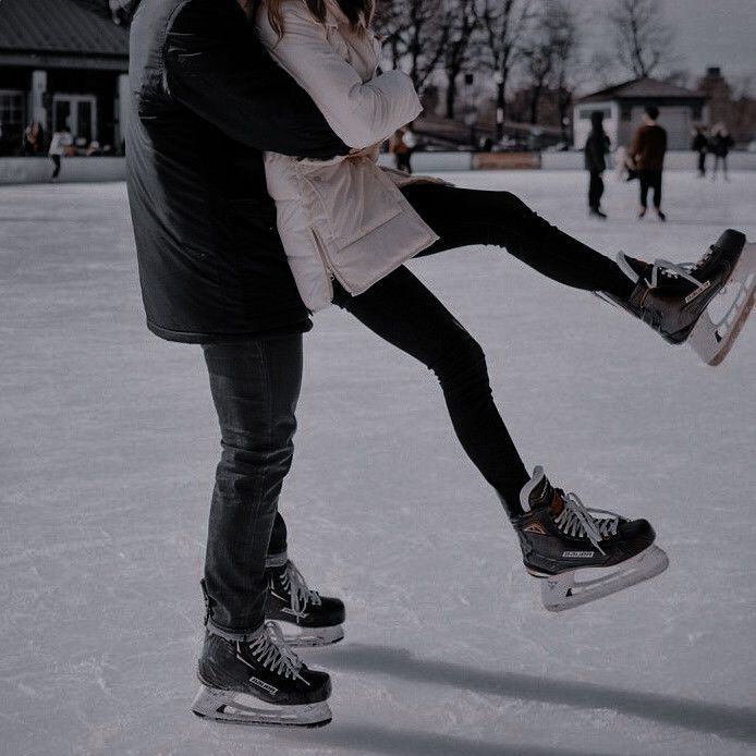 a man and woman are skating on the ice