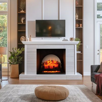 a living room filled with furniture and a fire place in front of a flat screen tv