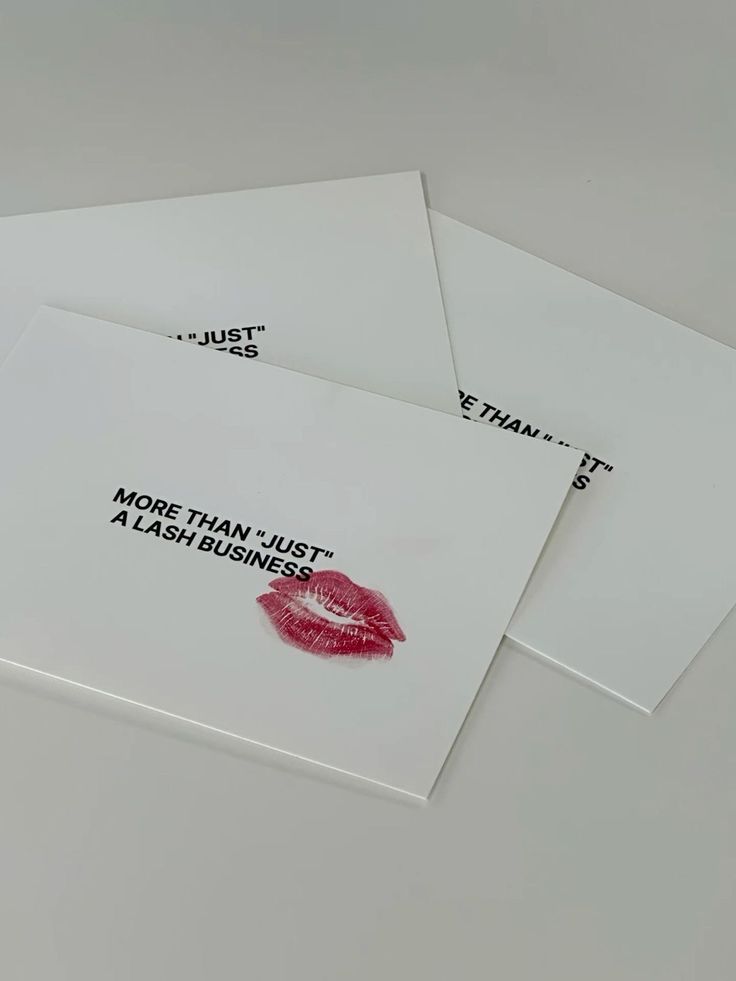 three white envelopes with red lipstick prints on them