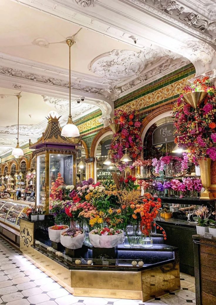 the interior of a flower shop with flowers in vases