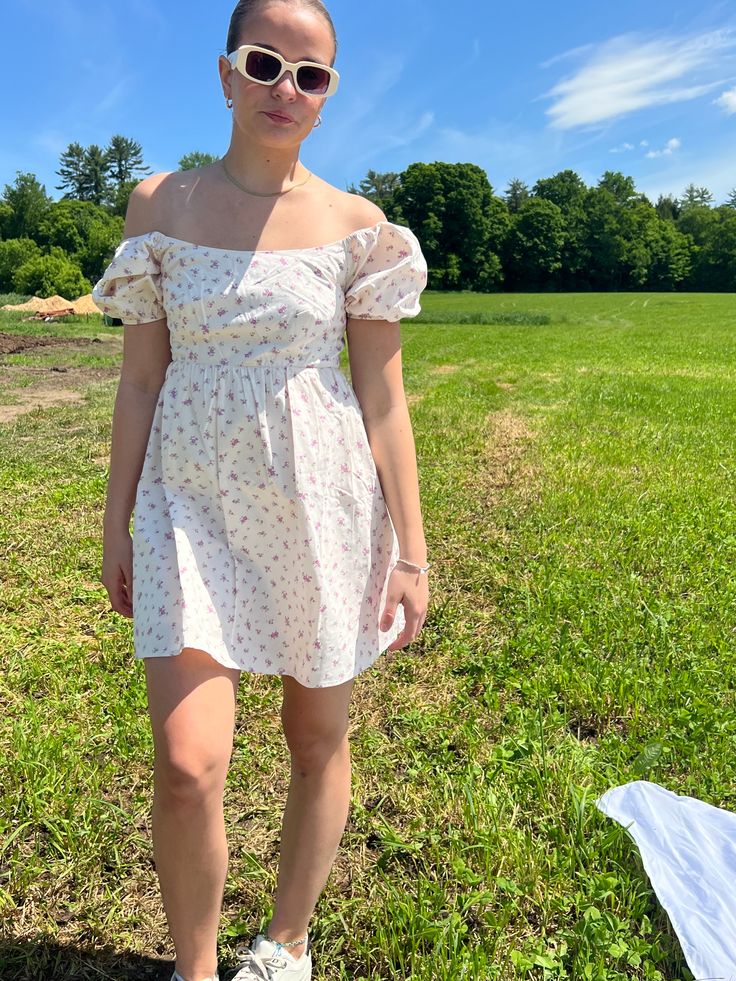 Introducing our Rosette Babydoll Dress, the perfect addition to your summer wardrobe. Made from 100% cotton, this floral mini dress exudes femininity and grace. The model is 5'3" and wearing a size small. Stay cool and stylish all summer long with this must-have dress that runs true to size. Size rec: S - 2-4 M - 4-6 L - 8-10 Cottagecore Mini Dress For Garden Party, Summer Floral Dress With Ditsy Print And Square Neck, Summer Ditsy Floral Print Dress With Square Neck, Cotton Sundress With Square Neck, Summer Mini Dress With Puff Sleeves For Garden Party, Summer Ditsy Floral Print Mini Dress With Puff Sleeves, Summer Floral Dress With Square Neck For Day Out, Cotton Square Neck Sundress For Day Out, Floral Mini Cotton Dress For Brunch