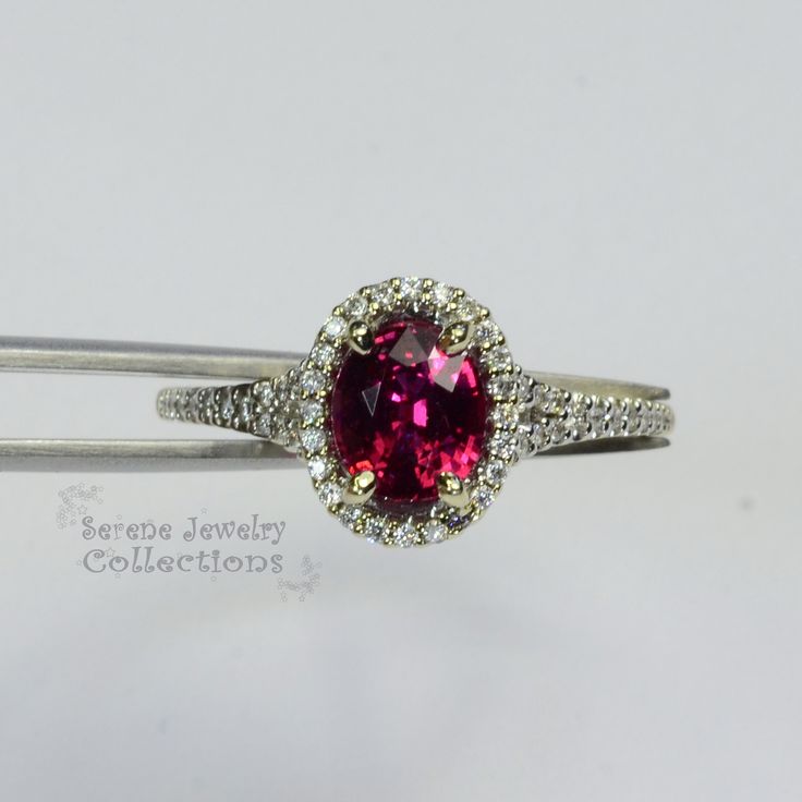 This 18k solid gold Vintage Ring has a sparkly red ruby as its center piece. Diamond rounds decorate a halo around the ruby as well as part of the shank Ring Size: 5.75 Total Weight: 2.87 grams Precious Metal: 18k solid gold Precious stones: -Reddish Orange Sapphire Center Stone: 0.24 carats, 5.7mm x 7.1mm -White Round Diamonds: 0.24 carats Dazzling Gia Certified Ruby Ring, Dazzling Oval Ruby Ring, Red Ruby Ring With Halo Setting For Formal Occasions, Lab-created Ruby Ring With Brilliant Cut In Oval Shape, Gia Certified Round Cut Ruby Ring Fine Jewelry, Gia Certified Round Cut Ruby Ring, Red Oval Sapphire Ring With Brilliant Cut, Formal Lab-created Ruby Ring With Halo Setting, Formal Lab-created Ruby Ring With Brilliant Cut