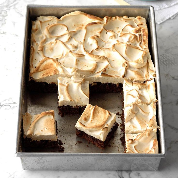 a pan filled with brownies covered in frosting