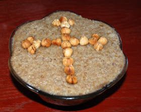 a bowl filled with oatmeal and nuts on top of a wooden table