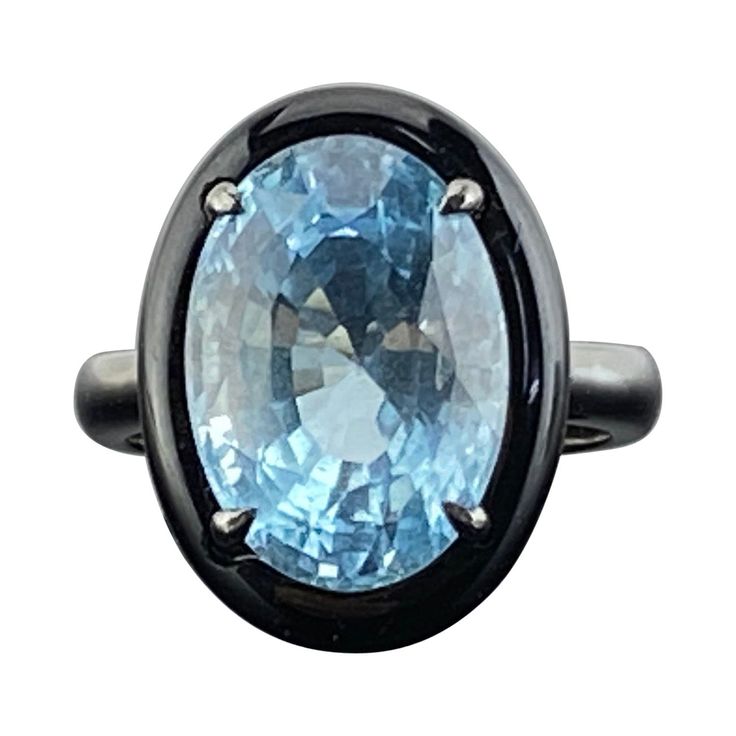 A stylish and classy ring, featuring a 7.76 carat aquamarine with a lovely sea-blue color. It is complemented by a piece of hand carved black onyx around it to give it a contrasting look . Hand-fabricated in 18K gold and polished in black rodium . The ring is currently sized at US 7, can be resized for free. We provide free express shipping world wide , and we gladly accept returns ! Please feel free to message us for more information. Timeless Blue Topaz Gemstone Ring, Elegant Moonstone Ring With Aquamarine Gemstone, Luxury Blue Topaz Ring With Polished Finish, Luxury Polished Blue Topaz Ring, Classic Blue Moonstone Ring For Formal Occasions, Luxury Blue Oval Emerald Ring, Elegant Blue Moonstone Ring For Formal Occasions, Luxury Blue Oval Moonstone Ring, Luxury Blue Moonstone Ring