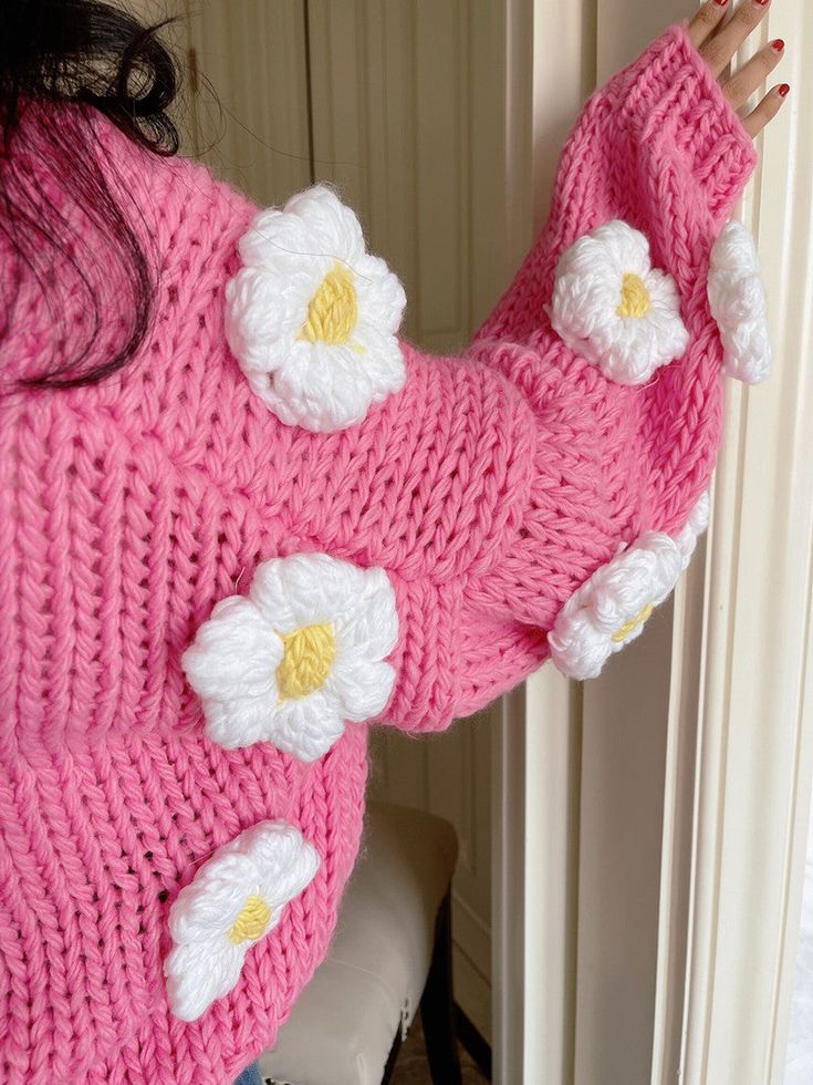 Thick chunky knit cropped cardigan with white puffy crochet flower pom poms all over. Each sweater weighs about 900g / 2lbs. 100% acrylic knit 24" across shoulders, 44" chest, 16-17" length Spring Cozy Sweater In Acrylic Yarn, Cozy Acrylic Yarn Sweater For Spring, Cute Chunky Knit Sweater For Spring, Cute Crochet Sweater For Spring, Spring Crochet Acrylic Sweater, Spring Acrylic Crochet Sweater, Cozy Pink Knit Cropped Sweater, Pink Cozy Cropped Sweater For Spring, Cozy Pink Cropped Sweater For Spring