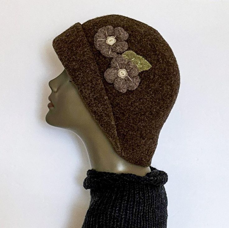 "This felted wool hat is the hat with an attitude   A unique and captivating hat resembling those hats of days gone by, this hat is approximately 22\" in circumference and can also be stretched if necessary.  The two felted flowers and leaf, which are sewn on, accentuate and add dimension to the Brown hat.  This style of hat can be worn in many different ways, totally up to you - there is no wrong way or right way - just the way you choose to wear it! The hat is crocheted by hand with quality wo Brown Wool Cloche Hat With Curved Brim, Winter Felt Hat, One Size Fits Most, Winter Felt Hat One Size, Winter Felt Hat One Size Fits Most, Winter Felt Beanie Hat, Brown Cloche Felt Hat For Winter, Brown Wool Cloche Felt Hat, Brown Wool Cloche Hat, Winter Mini Hats With Short Brim In Felt