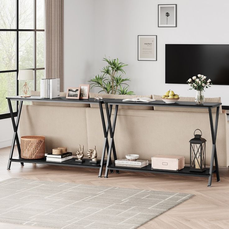 a living room with a large tv on the wall and two shelves holding various items