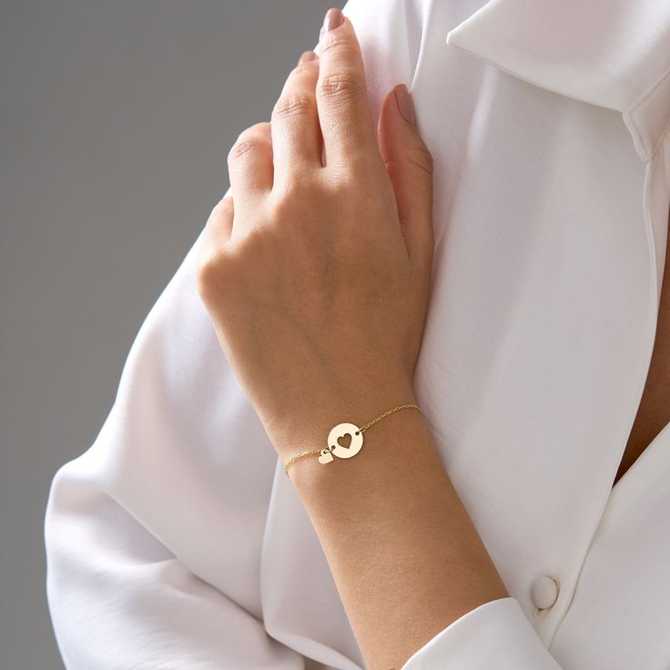 Celebrate timeless elegance with this Double Heart Bracelet in 14K solid gold. Featuring two interlocking heart charms, this dainty bracelet is perfect for everyday wear and special occasions. The double heart symbol represents love and friendship, making it an ideal gift for a loved one or a meaningful addition to your jewelry collection. Product Materials Options: 14K Yellow Gold, 14K White Gold, 14K Rose Gold Heart Dimensions: 12 mm / 0.42 inches in both height and width Thickness: 1 mm Choos Minimalist Yellow Gold Charm Bracelet For Anniversary, Yellow Gold Jubilee Heart Bracelet, Elegant Personalized Round Heart Bracelet, 14k Gold Heart Bracelet Gift, 14k Gold Promise Bracelets, Yellow Gold Heart Bracelet For Wedding, Minimalist Yellow Gold Heart Bracelet For Anniversary, 14k Yellow Gold Heart Bracelet For Anniversary, Yellow Gold Bracelet With Heart Charm