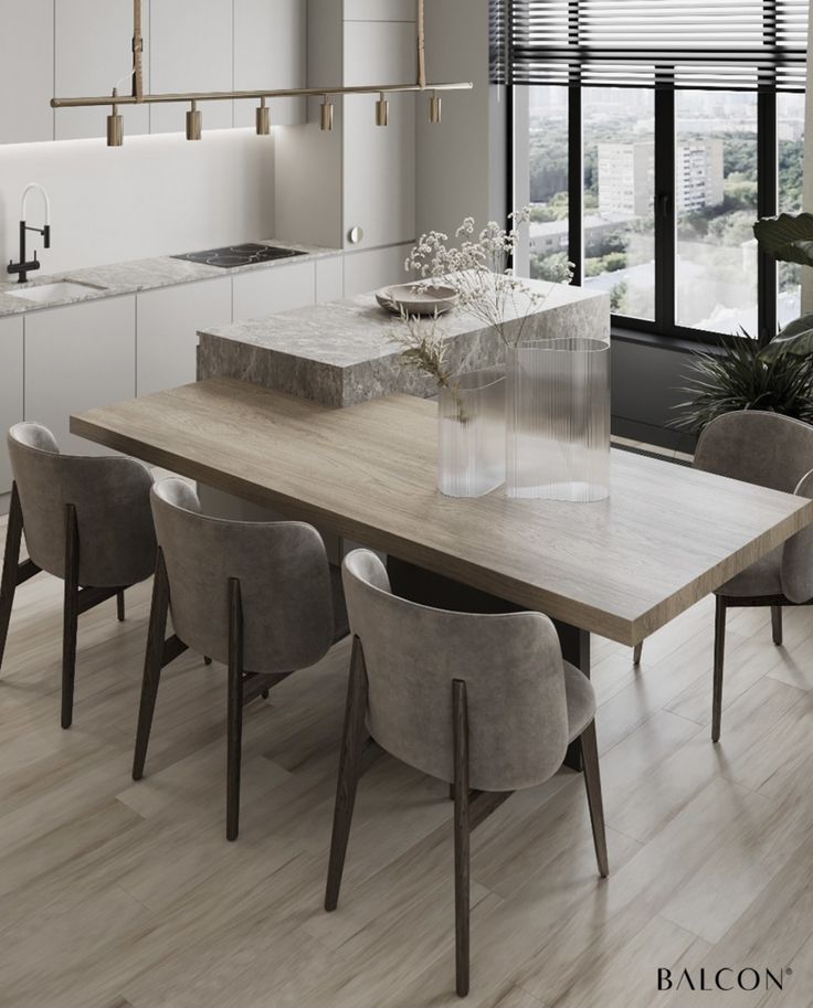 a modern kitchen with an island and dining table in the center, along with chairs