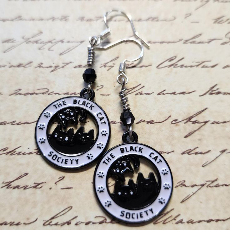 Enamel Black Cat Society Dangle Earrings with Black Faceted Glass Bead. Dangle approx 2".  Hypo-allergenic sterling silver ear wires. Black Cat Design Drop Earrings, Black Hypoallergenic Sterling Silver Jewelry, Black Hypoallergenic Adjustable Earrings, Black Hypoallergenic Metal Earrings, Hypoallergenic Black Metal Jewelry, Witchy Tips, Faceted Glass, Lebanon, Glass Bead