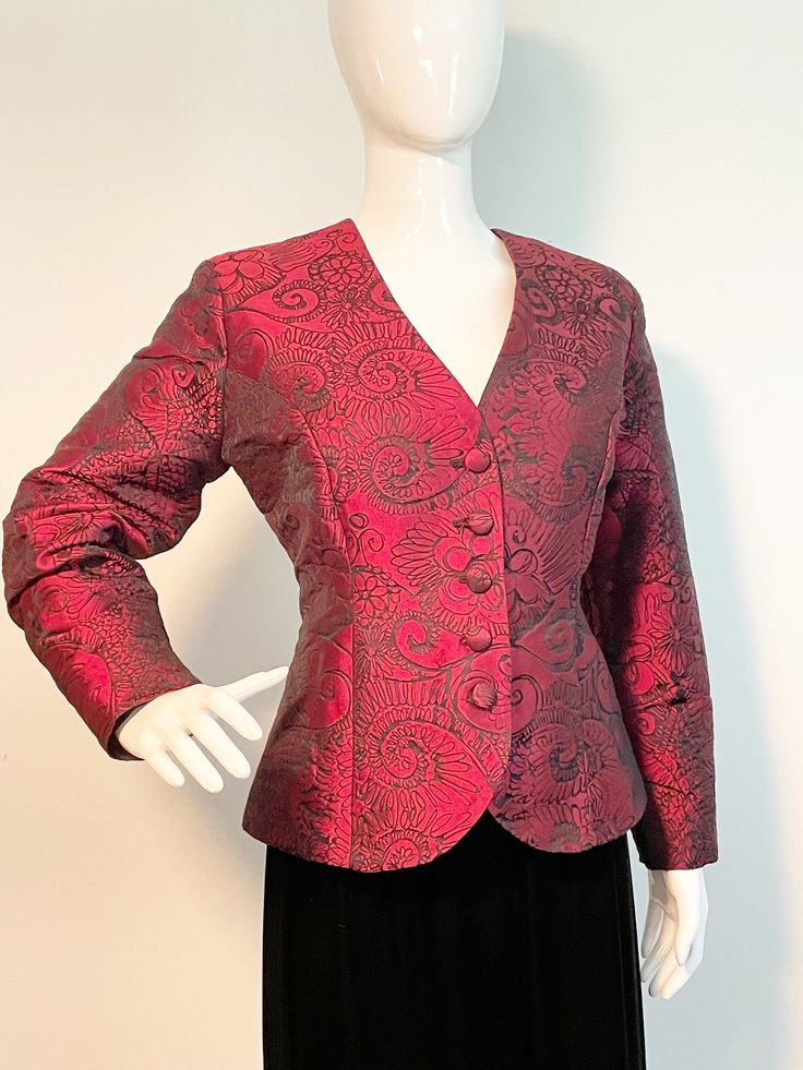 This is a beautifully tailored wine colored blazer.  It has an abstract floral design woven in black.  The jacket is fully lined and has light shoulder pads.  Buttons down the front with fabric covered buttons.  Appears to be custom made, incredible quality with taffeta sound and feel.  The perfect accompaniment to your LBD.  Size tag M.  No flaws noted. Check measurements carefully, no stretch. Measurements taken with jacket laying flat and doubled where appropriate. In order to determine fit w Abstract Floral Design, Floral Blazer, Vintage Blazer, Fabric Covered Button, Fitted Blazer, Womens Blazers, Wine Colored, Colored Blazer, Black Fits