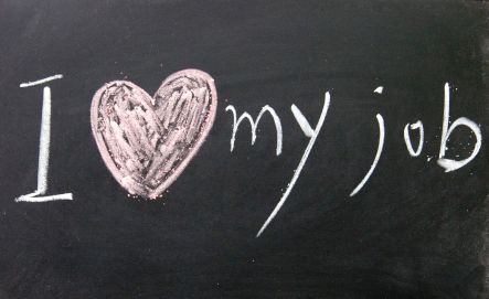 i love my job written on a blackboard with chalk in the shape of a heart