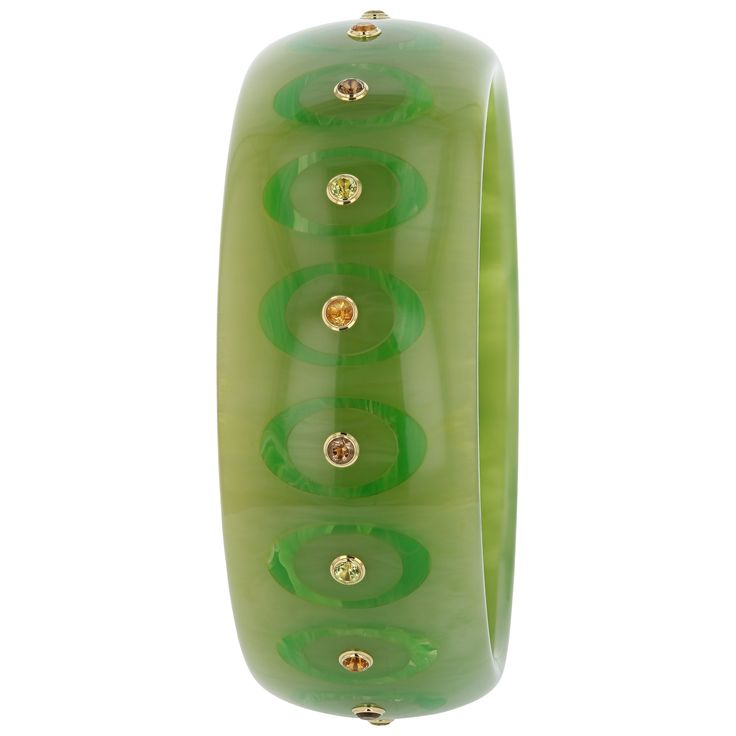 This bangle, from the Mark Davis Collector Line, is made of moss green marbled vintage bakelite. It has been precisely inlaid with tonal green ovals that are open in the center. The center of each ellipse features a brilliant citrine, peridot or smoky quartz. All stones have been bezel-set in 18k yellow gold. This is an extremely elegant and versatile piece. Metal 18-Karat Yellow Gold (Au750) Gemstones Citrine 0.58 ctwPeridot 0.77 ctwSmoky Quartz 0.58 ctw Dimensions Inner Diameter 66.00 mm (2.60 Bakelite Bangles, Green Oval, Vintage Bakelite, Moss Green, Smoky Quartz, Bezel Setting, Gift Necklace, Citrine, Ring Earrings