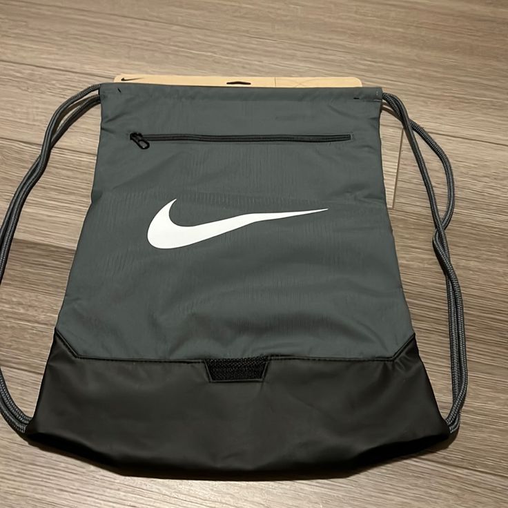 Gray Nike Drawstring Bag New With Tags Has A Zipper In The Front And The Nike Emblem Nike Black Backpack For Gym, Nike Black Gym Backpack, Casual Gray Backpack For Sports, Casual Gray Sports Backpack, Sporty Gray Sports Bags, Sporty Gray Gym Bag, Casual Gray Pouch Bag, Sporty Gray Bags For Daily Use, Sporty Gray Gym Bag For Everyday Use